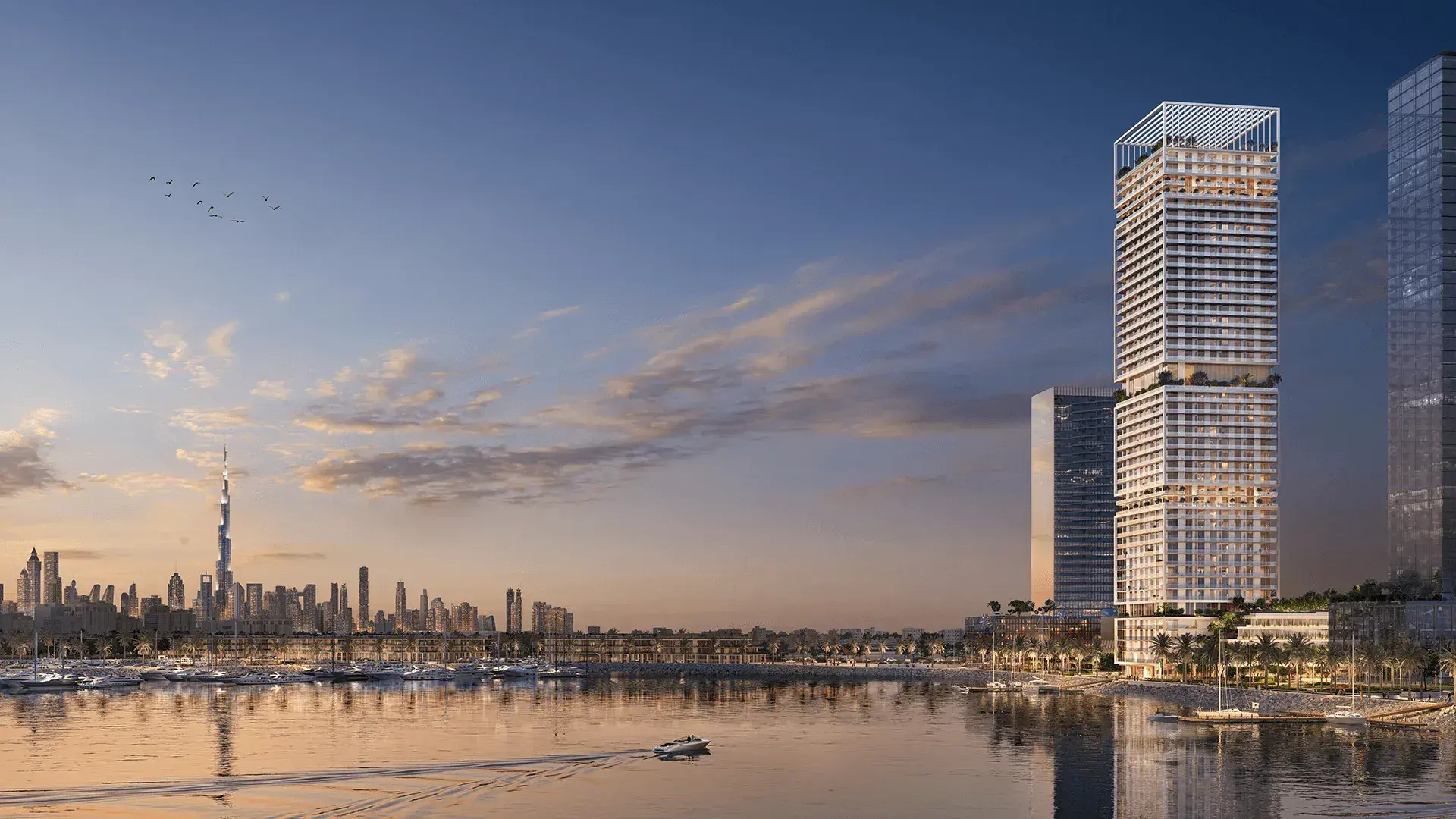 Saria tower on the waterfront with the Dubai skyline at dusk