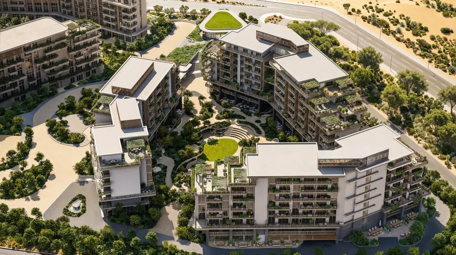 Aerial view of Arancia Yards' low-rise buildings around a green valley